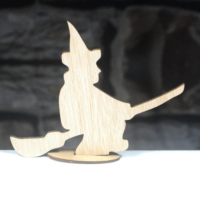 Wooden Halloween decoration, a Witch on a Broomstick, on a table top stand